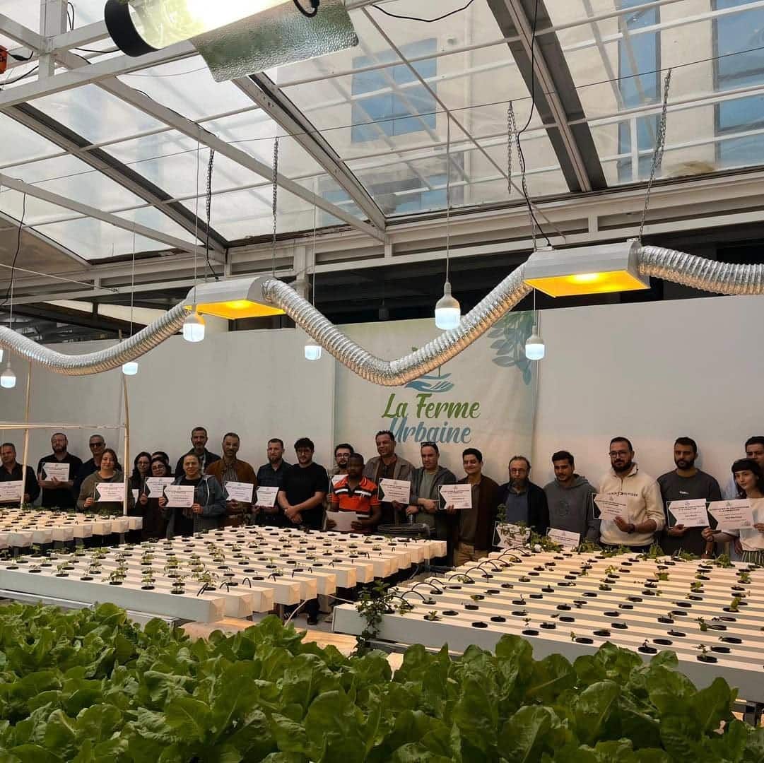 A group of participants receiving their hydroponics training certificates